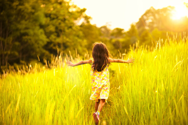 Child running through tall grass