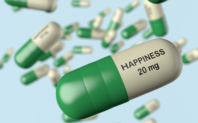 Green and white capsules, the largest one printed HAPPINESS 20 mg